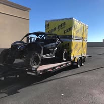 Car securely tied down on a transport trailer